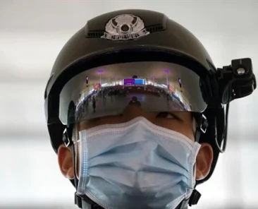 A police officer wearing a face mask at Wuhan Tianhe International Airport in Wuhan, Hubei Province, China, April 8, 2020 (AP photo by Ng Han Guan).